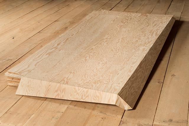 Rectangular plywood sheets on wood floor