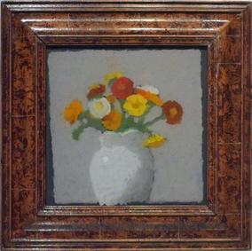 Yellow, red, and orange flowers in white vase in wood frame