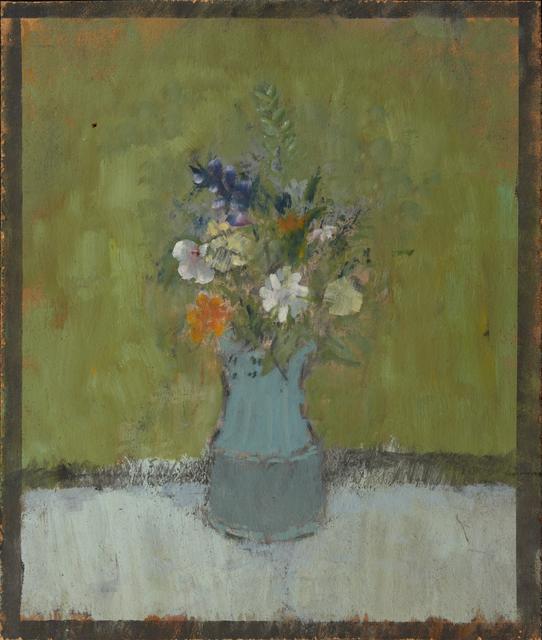 Boquet of flowers in blue vase on white table in front of green wall