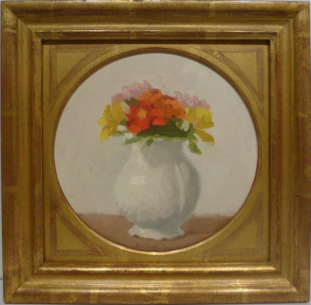 Orange and yellow flowers in white vase on brown table in a circle in a detailed gold frame