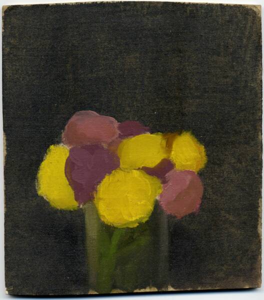 Yellow, pink, and purple flowers in glass jar in front of black background