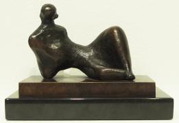 Bronze statue reclining on side on rectangular platform