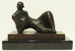 Curvy figure in bronze reclining on her side with left knee up