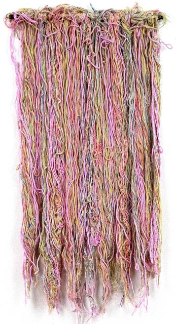 Pink, orange, green, and purple pastel strings hanging from wooden rod