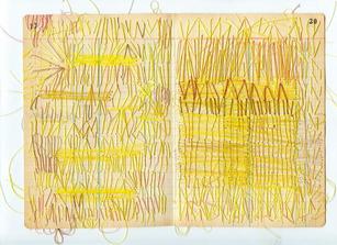 Yellow and brown thread sewn onto paper in short lines and small points