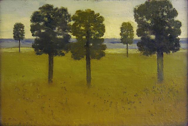 Three trees in foreground of grassy plain with two distant trees and blue hills