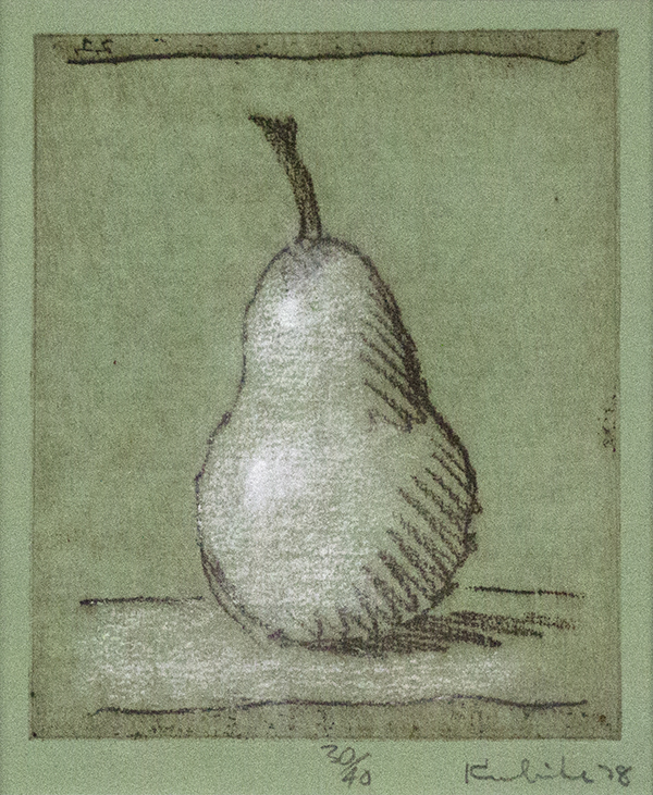 Single pear with long stem on table on green paper