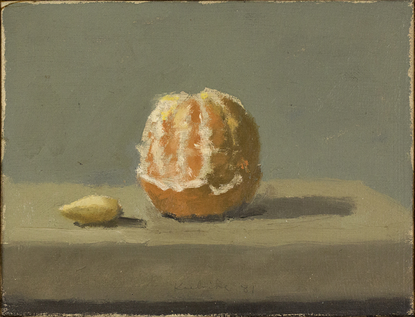 Half peeled orange on table with almond at left on table 