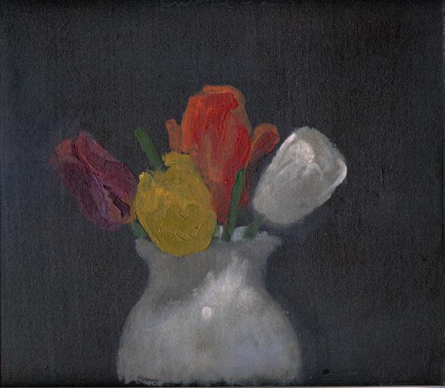 Purple, yellow, red, and white tulips in a white vase