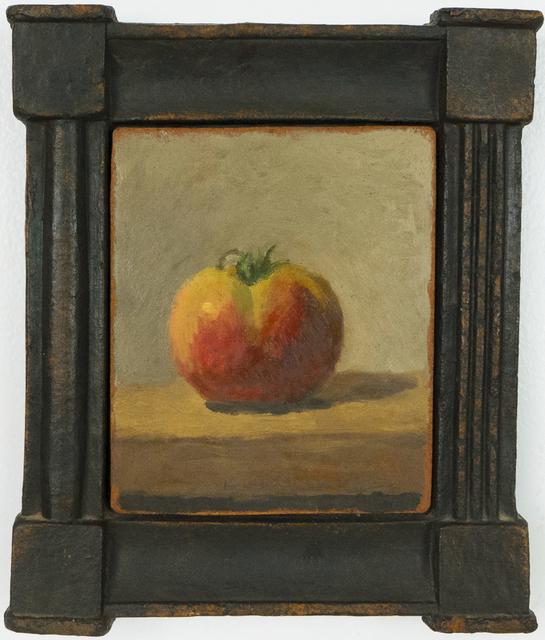 Yellow and red tomato on brown table in black frame