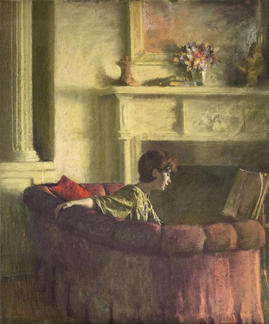 Woman with short brown hair on couch with arm extended in front of fireplace with flowers and painting