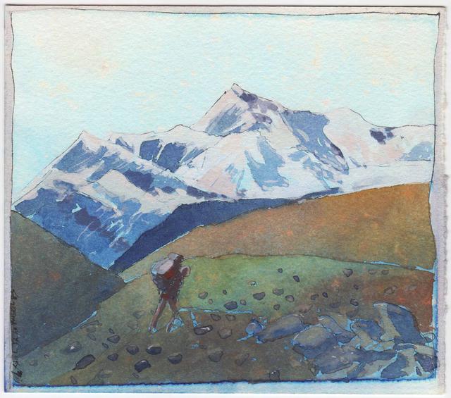 Figure in red shirt with backpack walks on green, rocky hill, with snowy mountains behind