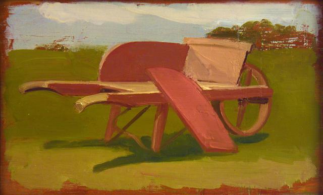 Red wheelbarrow in green landscape