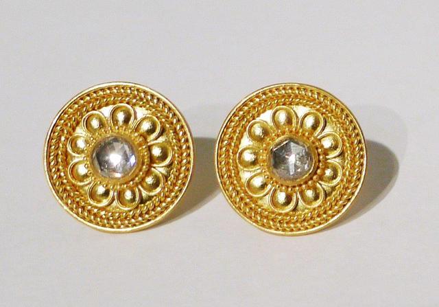 Pair of gold circular earrings with clear diamonds in center of each