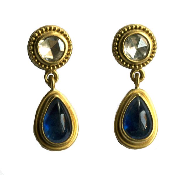 White diamond earrings at top with dangling blue sapphire beads on white background