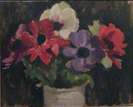 Purple, red, and white flowers with green leaves in grey vase on black background