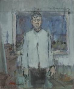 Portrait of the artist stadning with arms at his sides in grey shirt in front of landscape painting in his studio