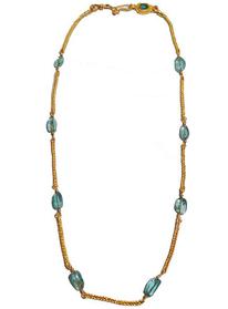 Gold necklace with emerald beans laid flat on white ground