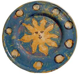 Blue plate with sun with small yellow circles on outer rim