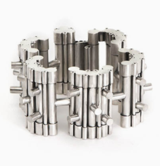 Silver bracelet composed of vertical cylinders interspersed with horizontal cylinders resting on white background