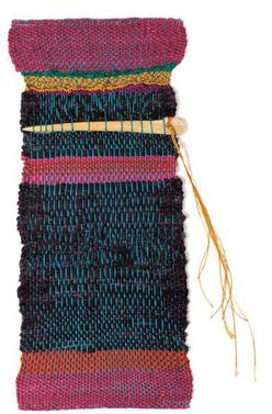 Rectangular weaving with magenta, red, blue, amd yellow stripes with needle shaped bone near the top, inserted horizontally