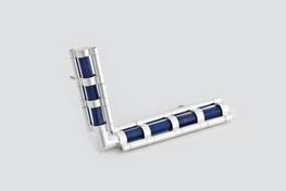 Brooch comprised of silver and lapis lazuli segments form two cylinders that meet at an angle