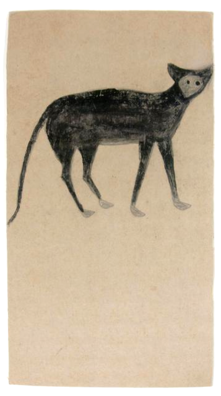 Black cat with grey paws and face on long rectangular tan paper